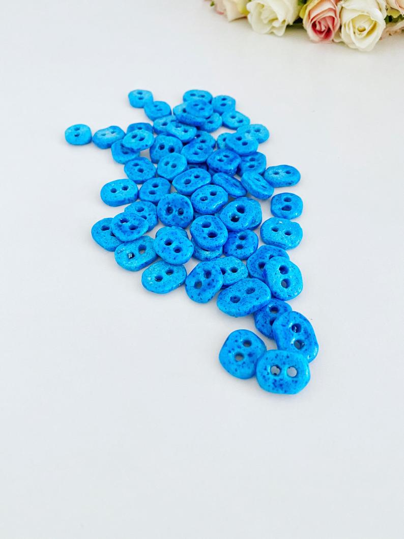 Handmade Evil Eye Beads in turquoise color with two holes, perfect for jewelry making.