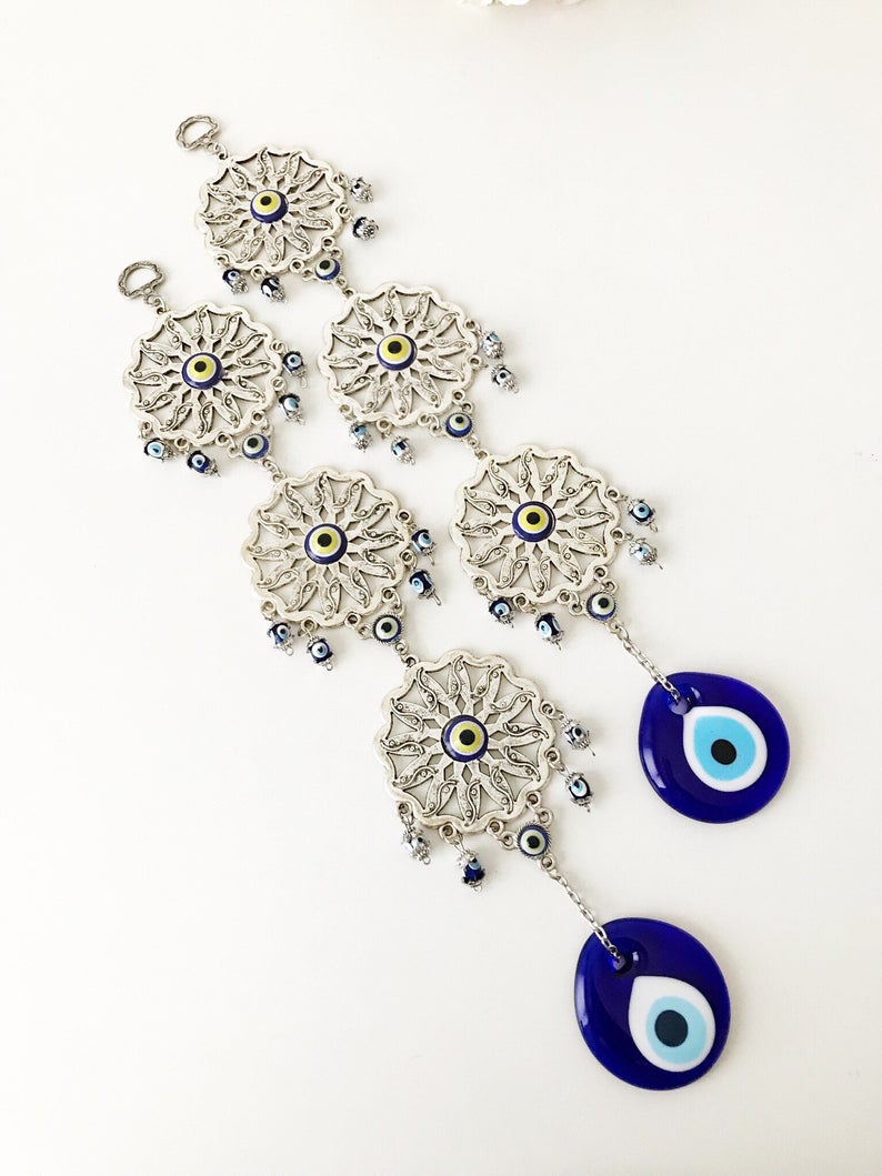 Handmade Evil Eye Blue Wall Decor featuring three sunflowers, symbolizing protection and good luck, crafted from metal.