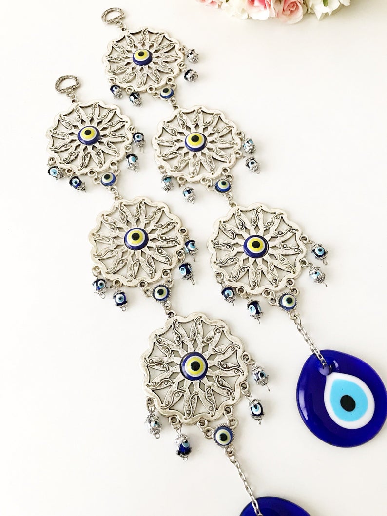 Handmade Evil Eye Blue Wall Decor featuring three sunflowers, symbolizing protection and good luck, crafted from metal.