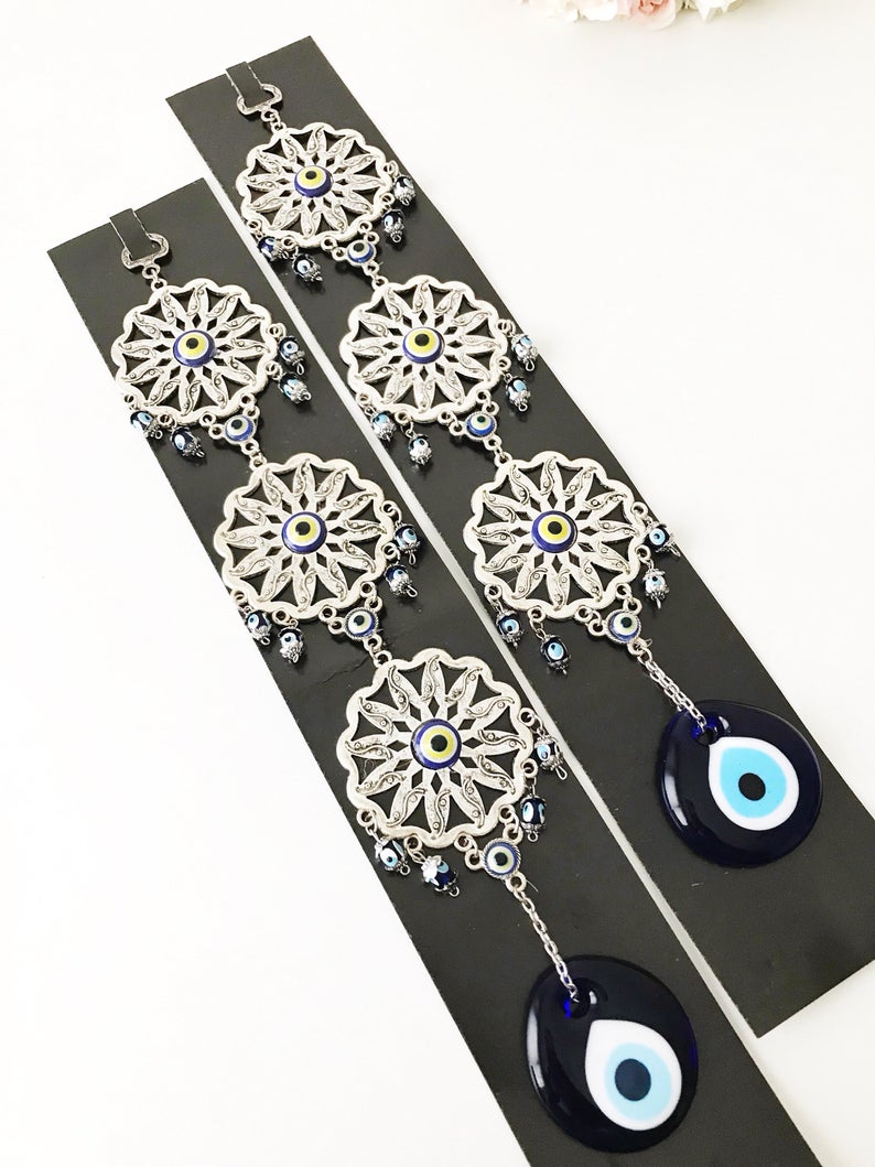 Handmade Evil Eye Blue Wall Decor featuring three sunflowers, symbolizing protection and good luck, crafted from metal.