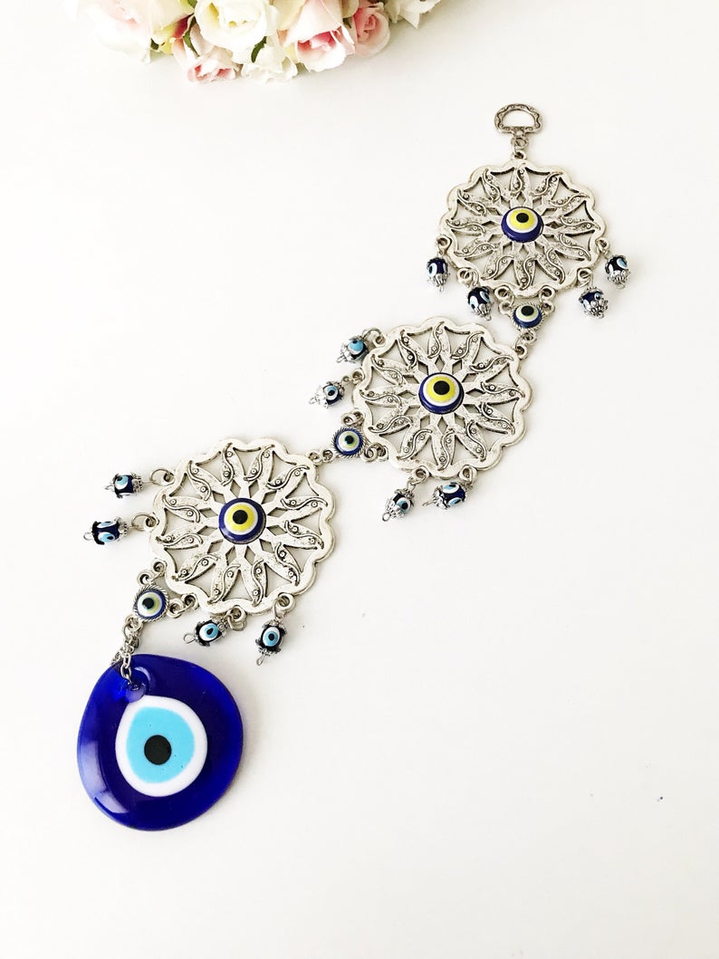 Handmade Evil Eye Blue Wall Decor featuring three sunflowers, symbolizing protection and good luck, crafted from metal.