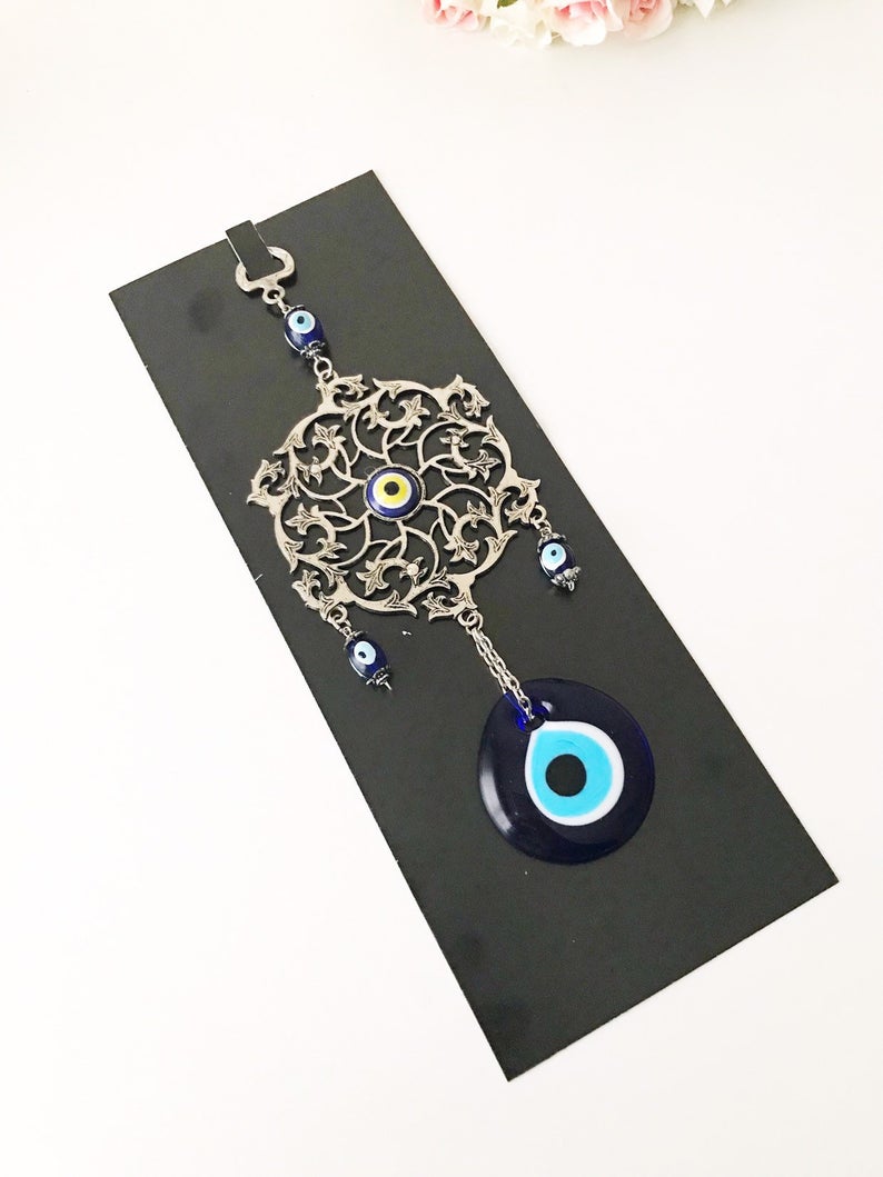 Evil Eye Blue Wall Decor featuring a round metal figure with a vibrant blue evil eye design, measuring 22cm in total length.