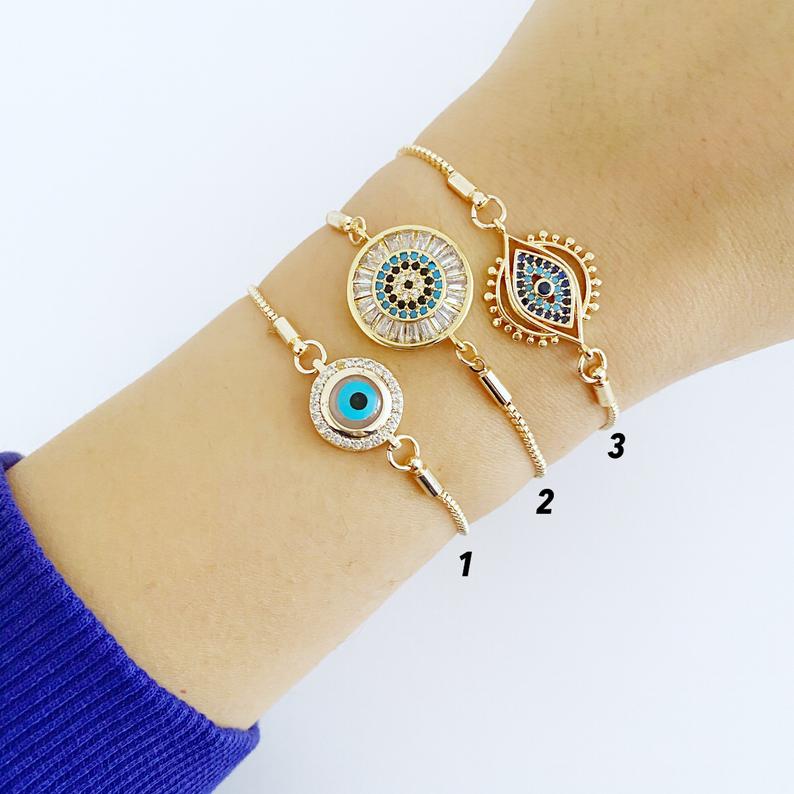 A beautiful adjustable Evil Eye Bracelet featuring a blue evil eye charm and sparkling cubic zirconia stones, crafted from tarnish-resistant stainless steel.