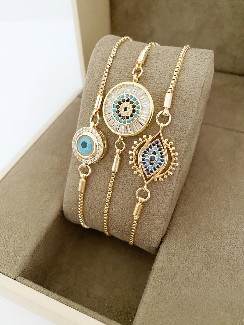 A beautiful adjustable Evil Eye Bracelet featuring a blue evil eye charm and sparkling cubic zirconia stones, crafted from tarnish-resistant stainless steel.