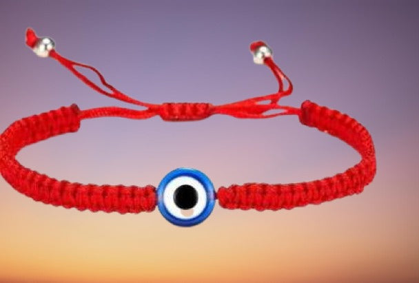 A handmade Evil Eye Bracelet featuring a ceramic evil eye on an adjustable waxed cord, symbolizing protection and friendship.