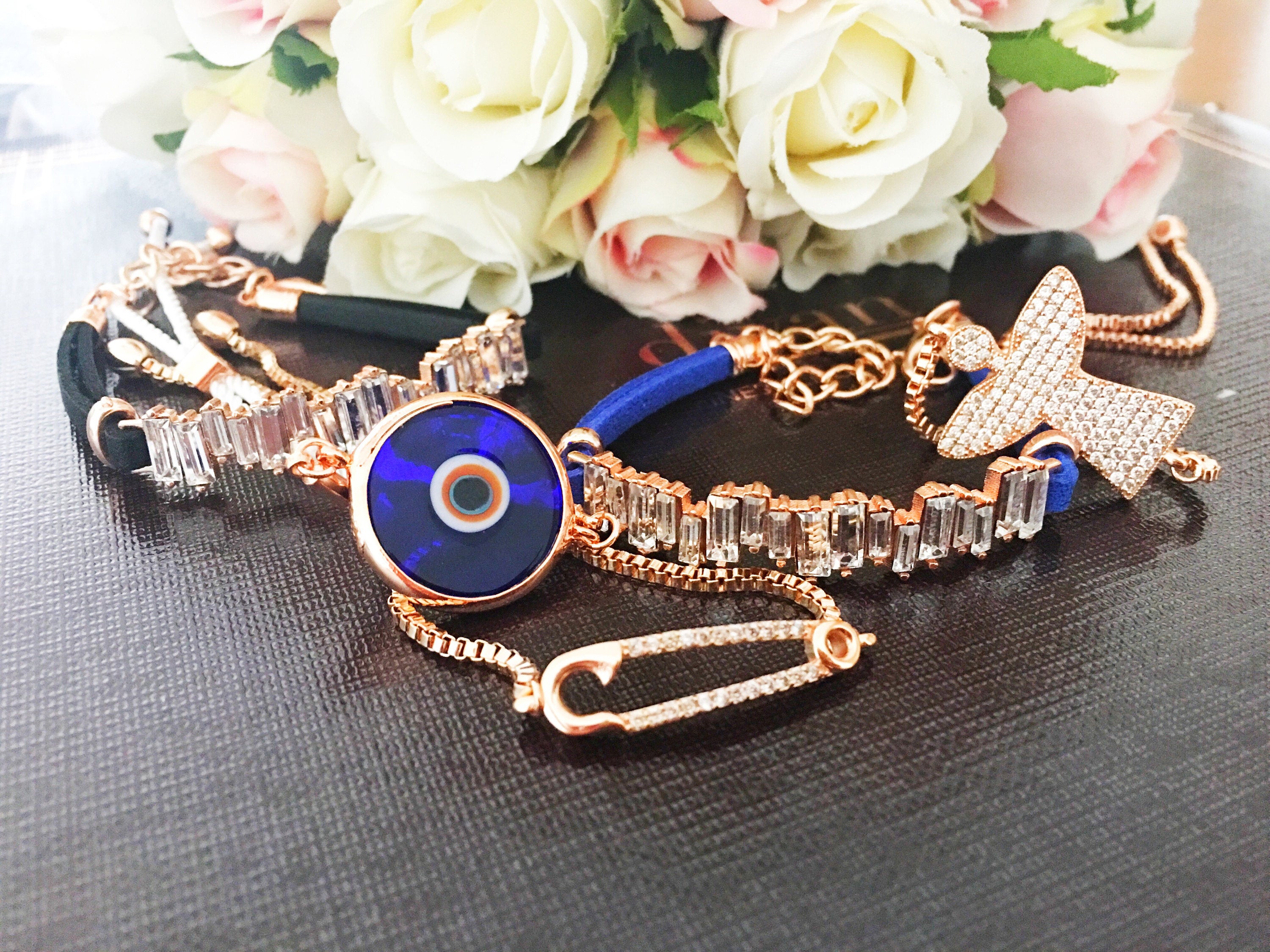 A stunning rose gold Evil Eye Bracelet featuring adjustable styles, made from stainless steel and adorned with Murano glass and zircon.