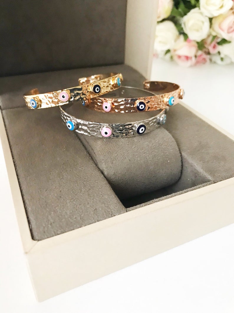 Evil Eye Bracelet featuring a movable oval charm, available in rose gold, gold, and silver, made from tarnish-resistant stainless steel.