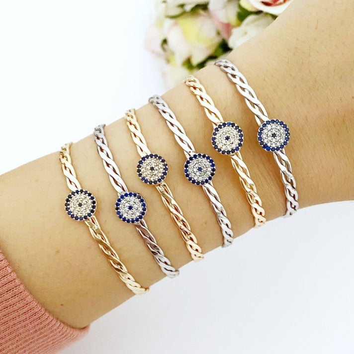 A beautiful evil eye bracelet featuring a movable charm, adjustable design, and available in silver and gold finishes, made from durable stainless steel.