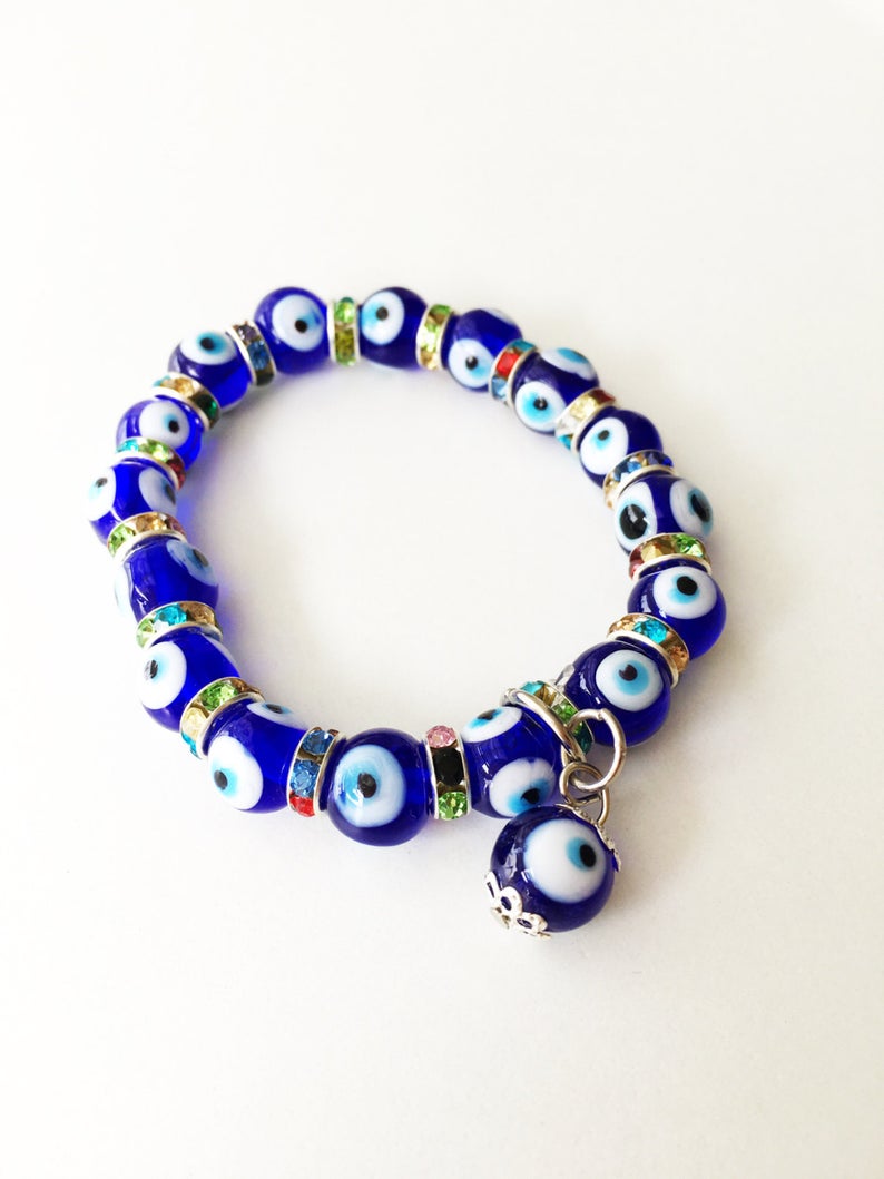 A beautiful stretchable Evil Eye Bracelet featuring turquoise and blue glass beads, symbolizing protection and style.