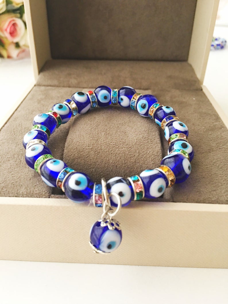 A beautiful stretchable Evil Eye Bracelet featuring turquoise and blue glass beads, symbolizing protection and style.