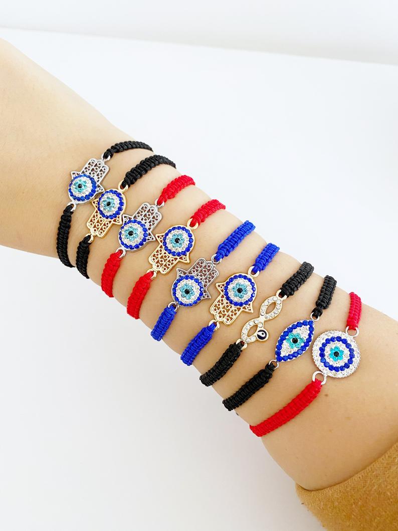 Handmade Evil Eye Bracelet featuring a central evil eye symbol on an adjustable black macramé band, available in 21 unique styles.