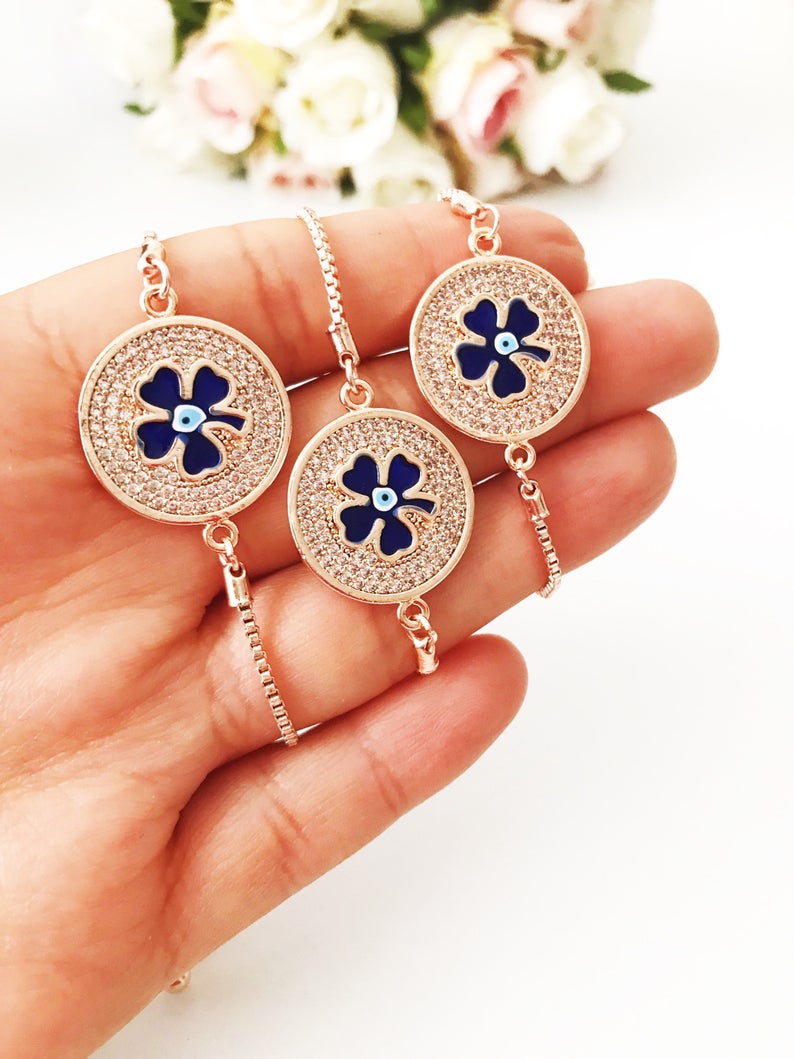 Handmade Evil Eye Bracelet featuring a blue evil eye charm and four leaf clover disc, elegantly designed with rose gold plating.