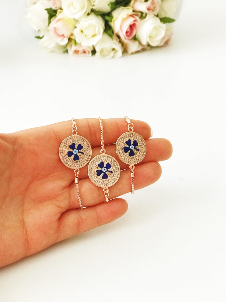 Handmade Evil Eye Bracelet featuring a blue evil eye charm and four leaf clover disc, elegantly designed with rose gold plating.