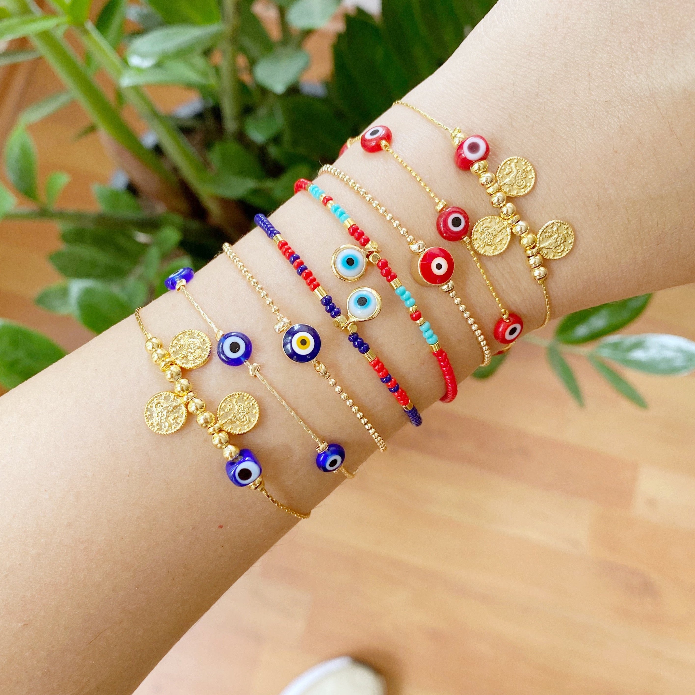 Handmade Evil Eye Bracelet featuring a gold chain with blue and red evil eye beads, symbolizing protection and luck.