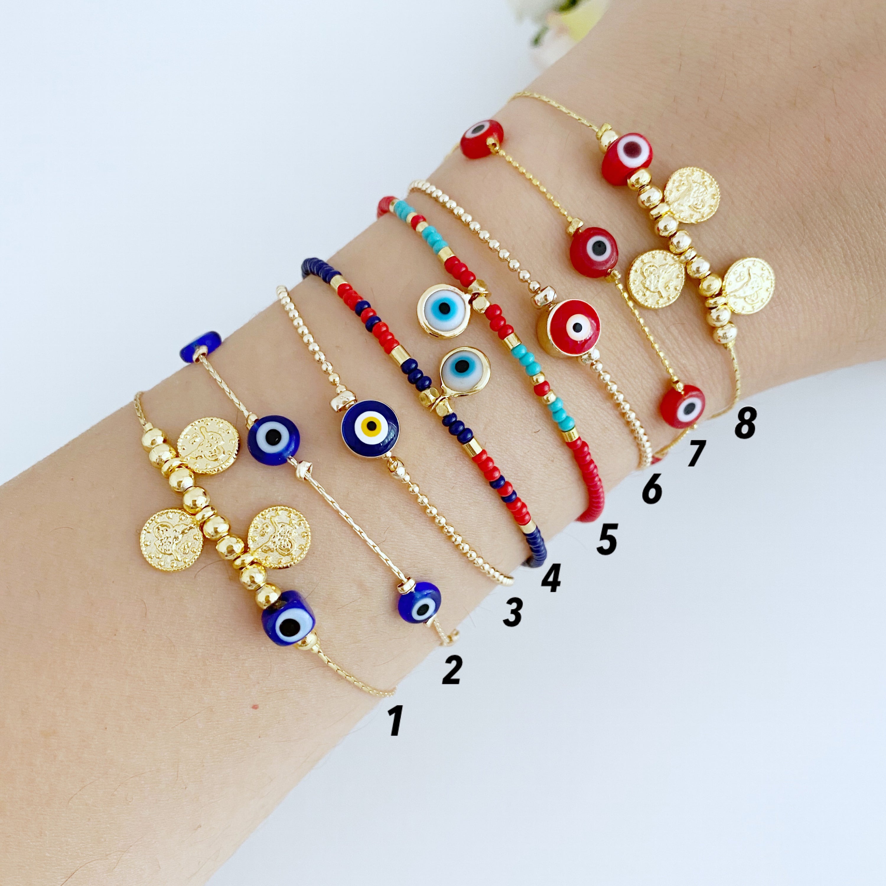 Handmade Evil Eye Bracelet featuring a gold chain with blue and red evil eye beads, symbolizing protection and luck.