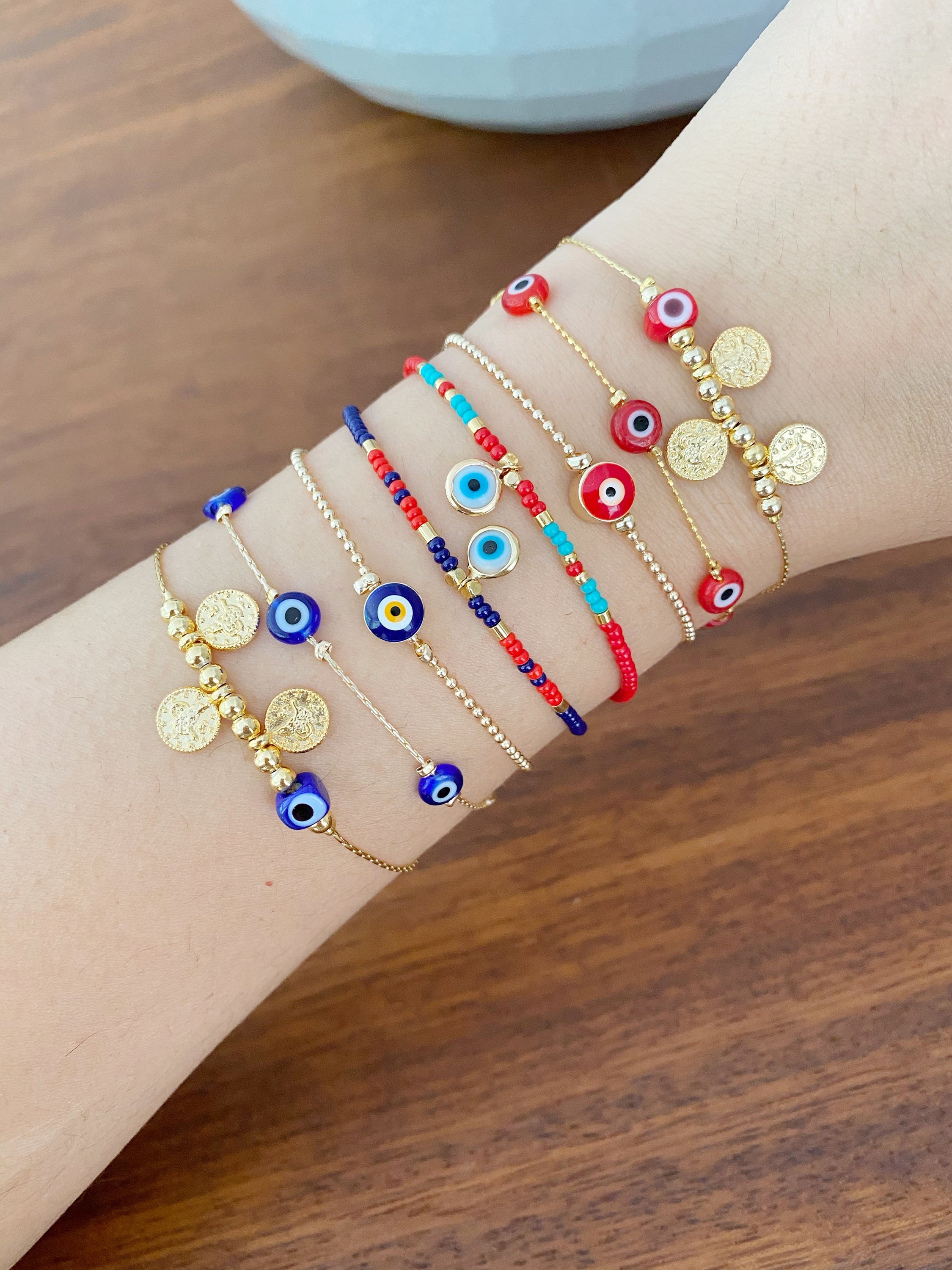 Handmade Evil Eye Bracelet featuring a gold chain with blue and red evil eye beads, symbolizing protection and luck.