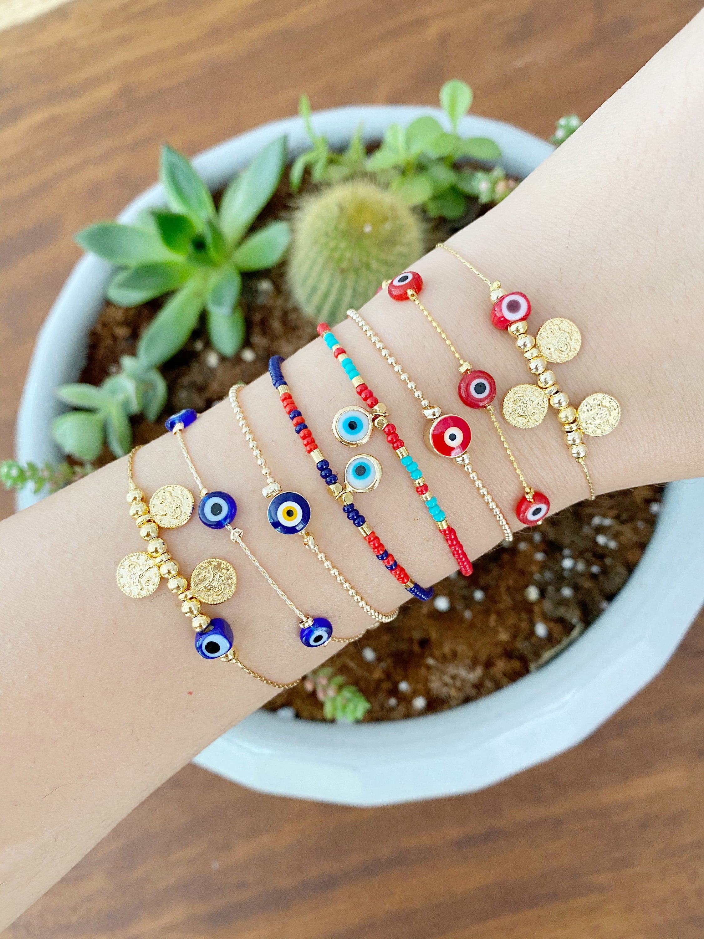 Handmade Evil Eye Bracelet featuring a gold chain with blue and red evil eye beads, symbolizing protection and luck.