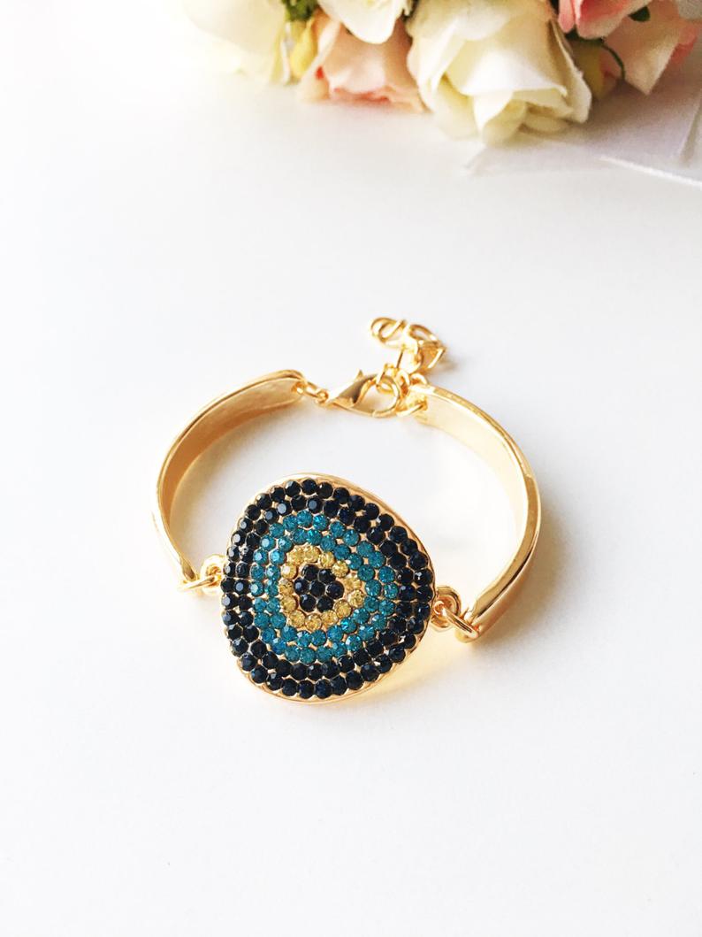 A beautifully crafted Gold Evil Eye Bracelet featuring a zircon charm on a gold chain, showcasing elegance and protection.