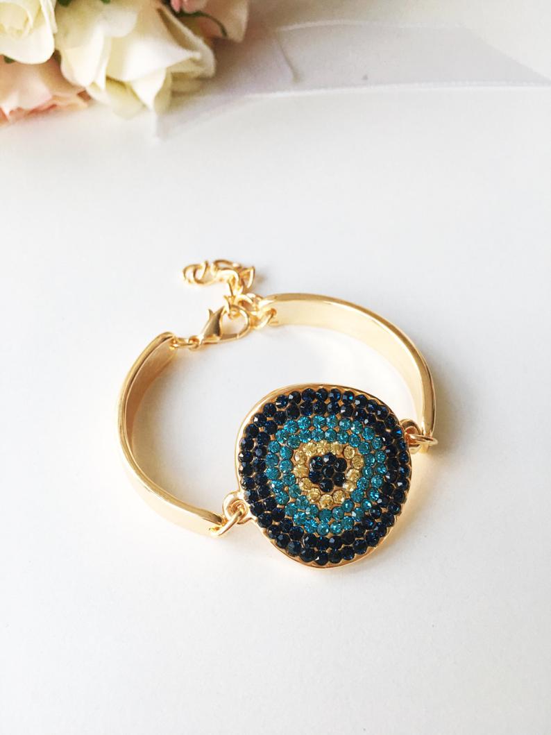 A beautifully crafted Gold Evil Eye Bracelet featuring a zircon charm on a gold chain, showcasing elegance and protection.