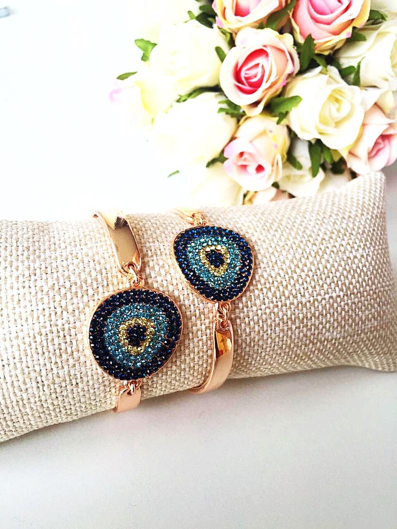 A beautifully crafted Gold Evil Eye Bracelet featuring a zircon charm on a gold chain, showcasing elegance and protection.