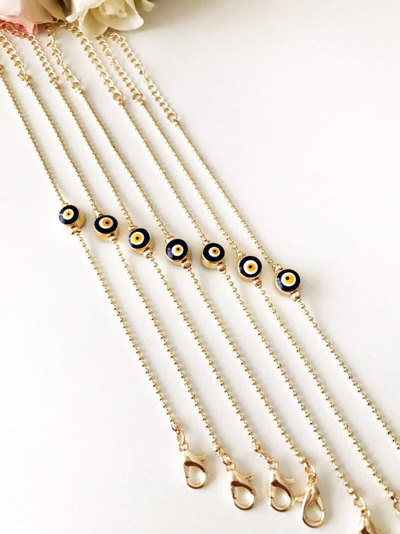 A beautiful gold evil eye bracelet featuring a blue evil eye bead, adjustable stainless steel chain, and available in four colors.