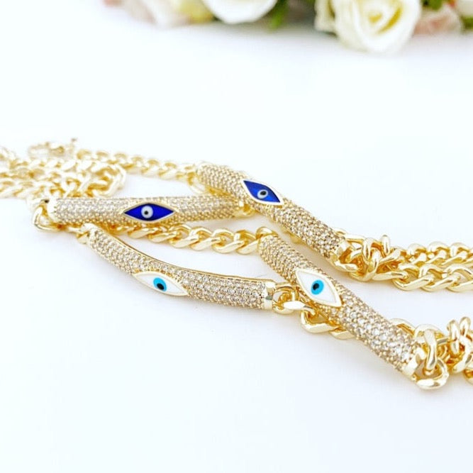 Evil Eye Bracelet featuring a gold link chain with blue and white evil eye charms, symbolizing protection and style.