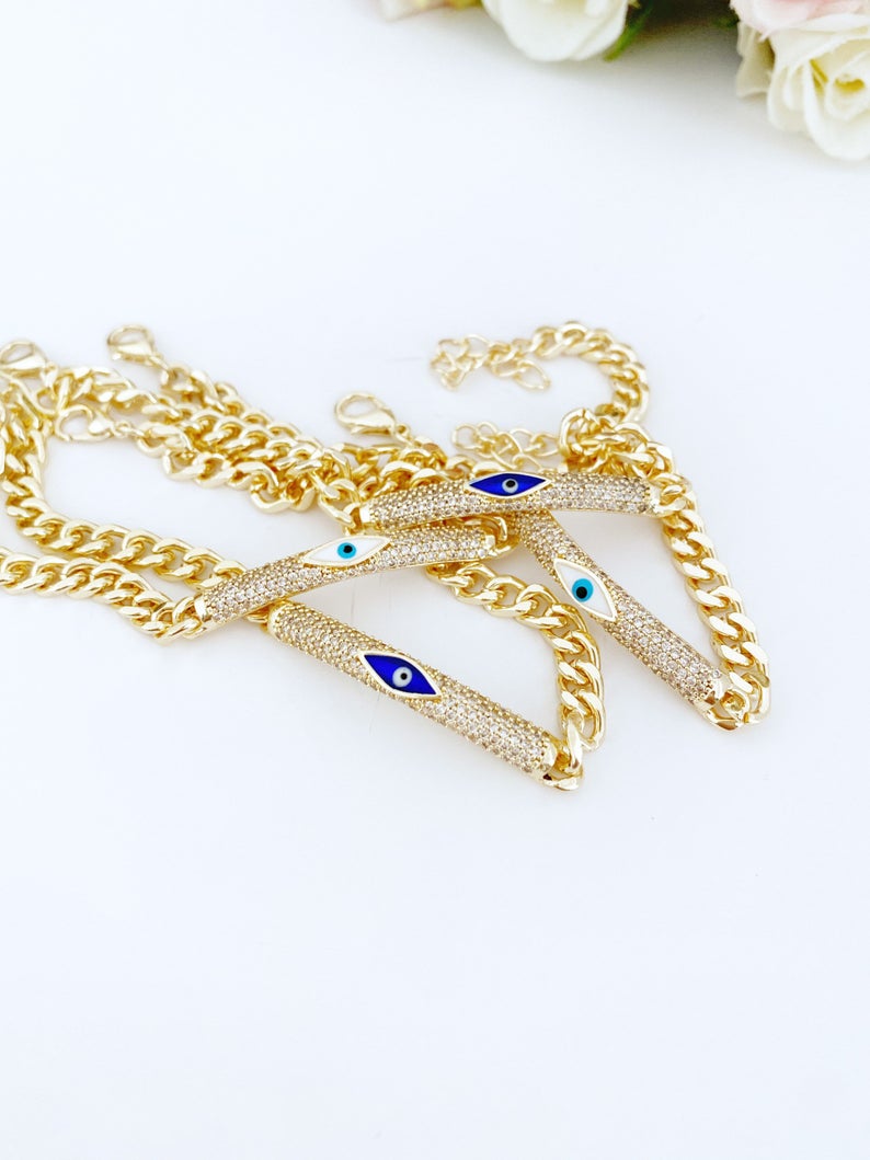 Evil Eye Bracelet featuring a gold link chain with blue and white evil eye charms, symbolizing protection and style.