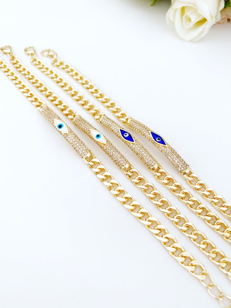 Evil Eye Bracelet featuring a gold link chain with blue and white evil eye charms, symbolizing protection and style.