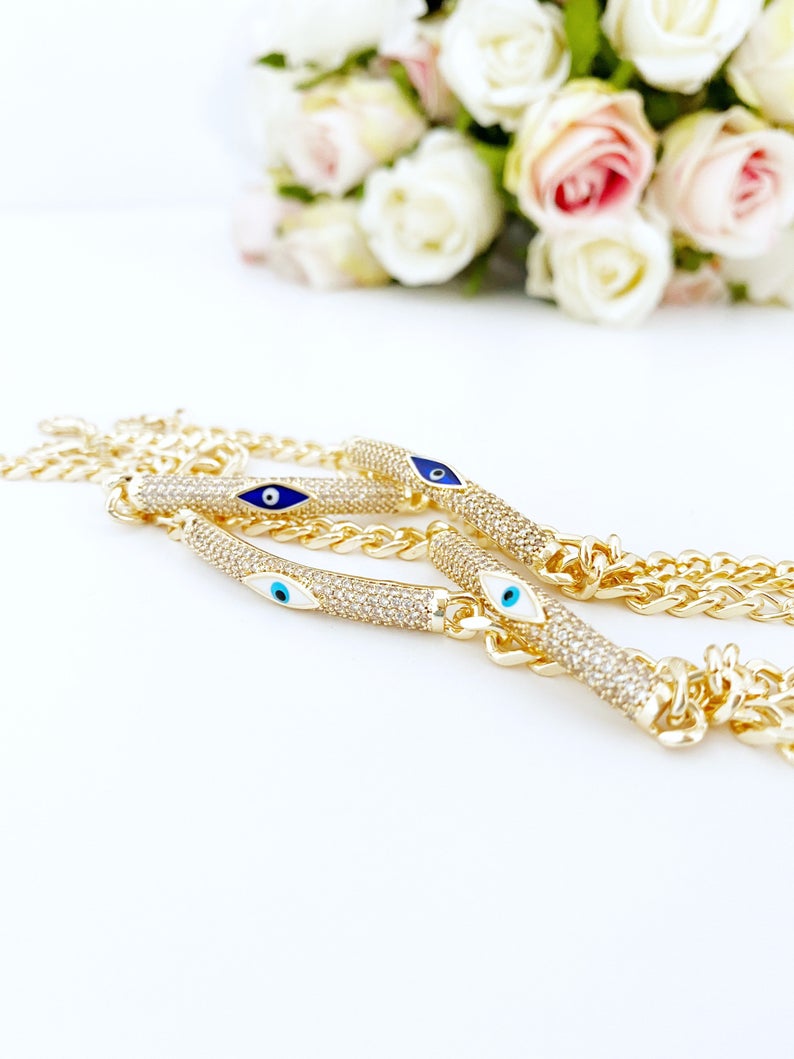 Evil Eye Bracelet featuring a gold link chain with blue and white evil eye charms, symbolizing protection and style.