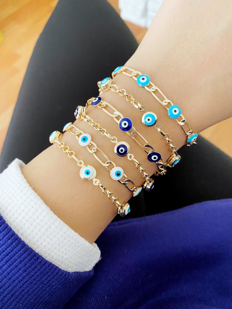 Elegant Evil Eye Bracelet featuring a gold link chain and blue evil eye charms, symbolizing protection and good luck.