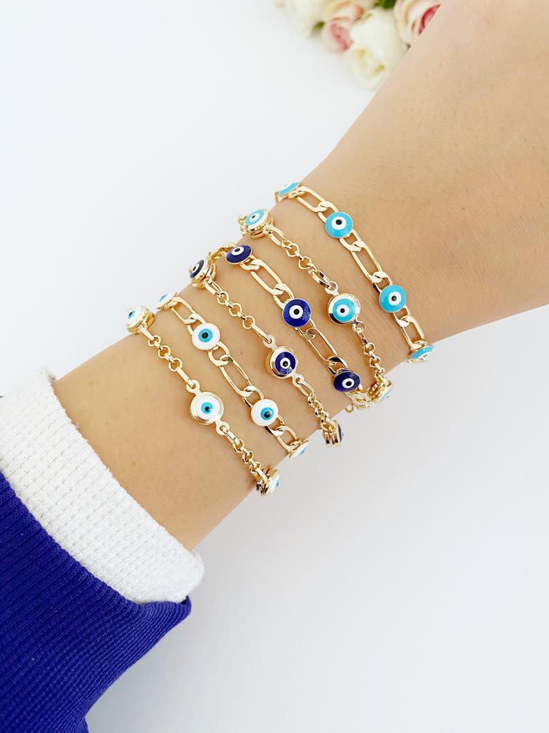 Elegant Evil Eye Bracelet featuring a gold link chain and blue evil eye charms, symbolizing protection and good luck.