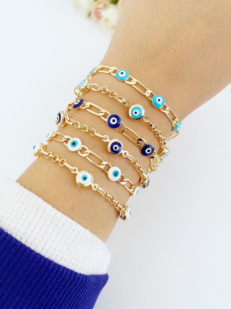 Elegant Evil Eye Bracelet featuring a gold link chain and blue evil eye charms, symbolizing protection and good luck.