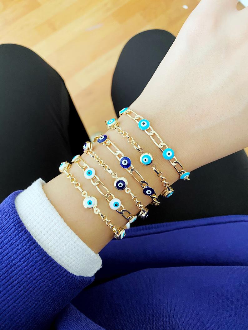 Elegant Evil Eye Bracelet featuring a gold link chain and blue evil eye charms, symbolizing protection and good luck.