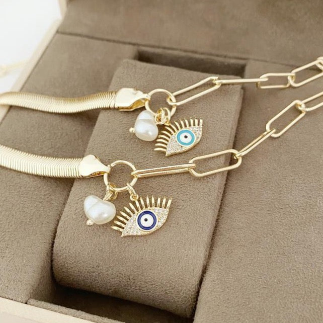 Elegant Evil Eye Bracelet featuring a gold oval link chain and a blue evil eye charm with a pearl accent.