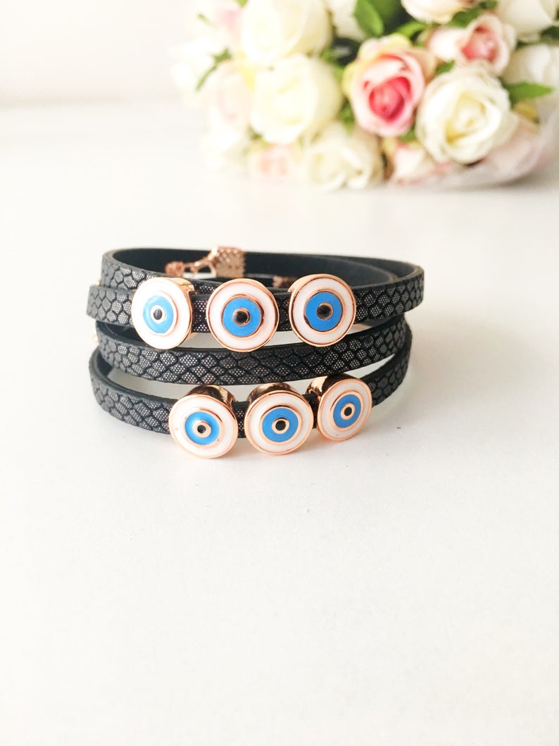 Handmade Evil Eye Bracelet featuring a blue charm on a leather strand, adjustable design, and tarnish-resistant stainless steel.