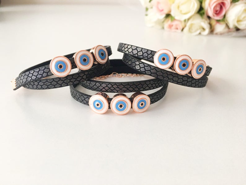 Handmade Evil Eye Bracelet featuring a blue charm on a leather strand, adjustable design, and tarnish-resistant stainless steel.