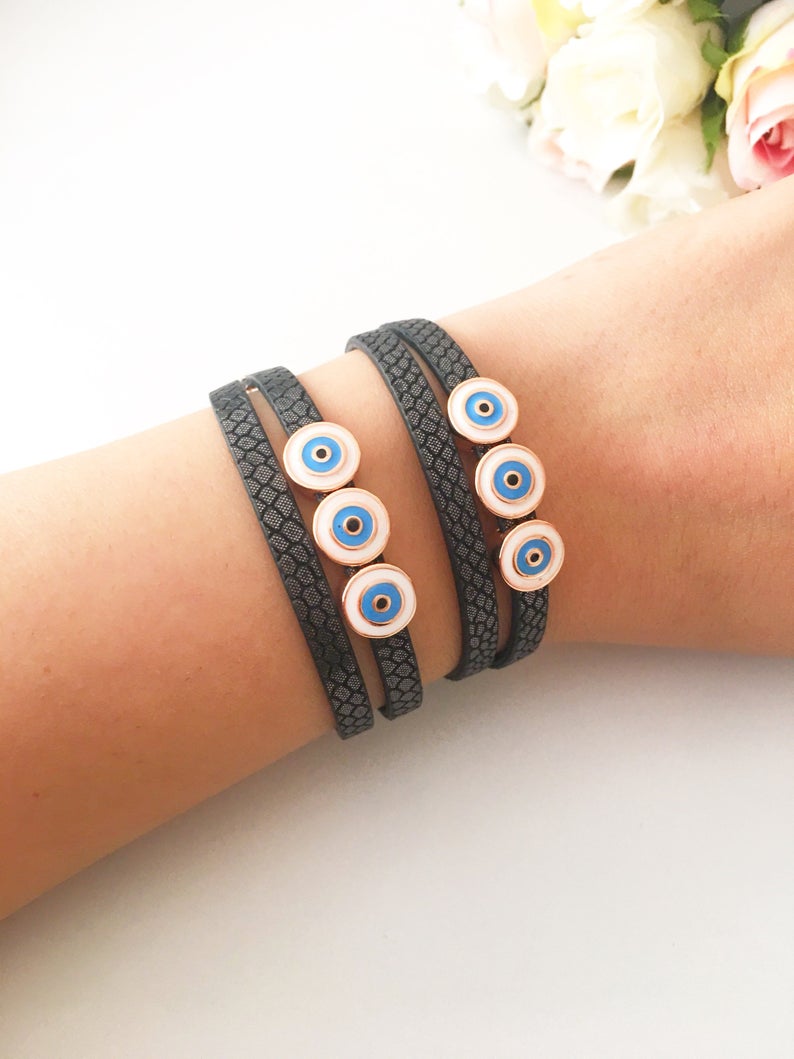 Handmade Evil Eye Bracelet featuring a blue charm on a leather strand, adjustable design, and tarnish-resistant stainless steel.