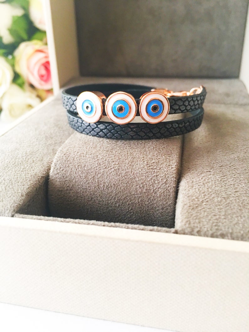 Handmade Evil Eye Bracelet featuring a blue charm on a leather strand, adjustable design, and tarnish-resistant stainless steel.