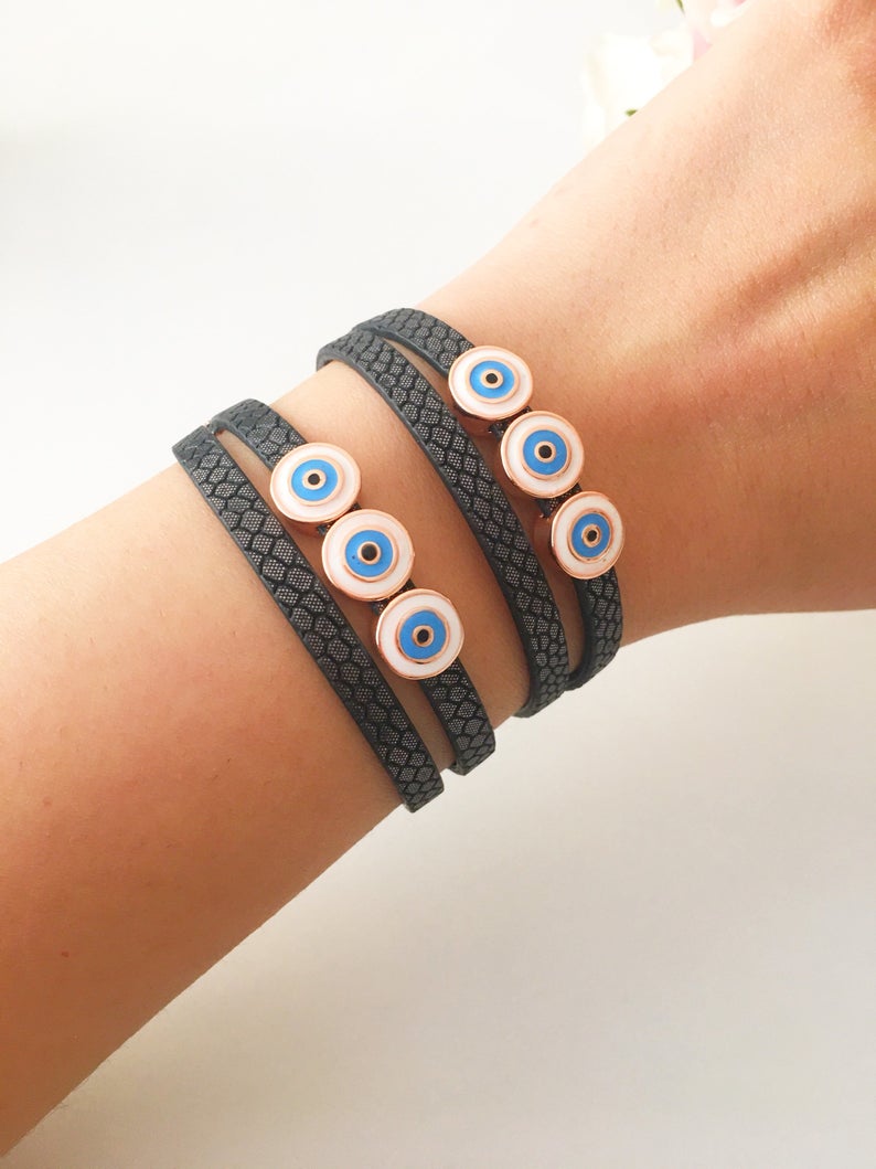 Handmade Evil Eye Bracelet featuring a blue charm on a leather strand, adjustable design, and tarnish-resistant stainless steel.