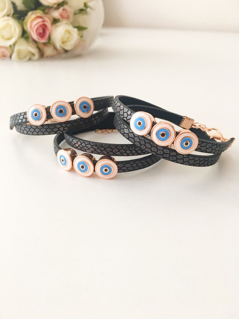 Handmade Evil Eye Bracelet featuring a blue charm on a leather strand, adjustable design, and tarnish-resistant stainless steel.