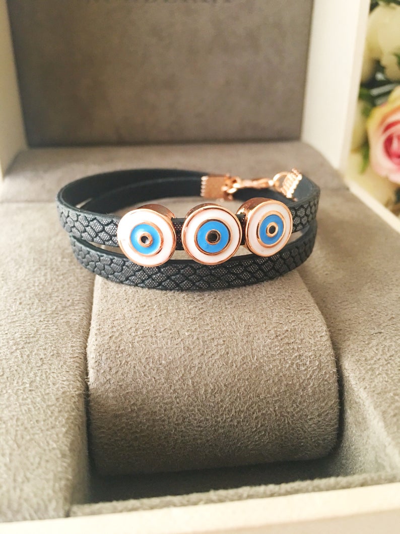 Handmade Evil Eye Bracelet featuring a blue charm on a leather strand, adjustable design, and tarnish-resistant stainless steel.