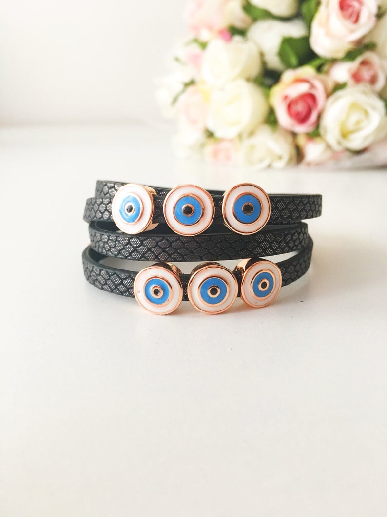 Handmade Evil Eye Bracelet featuring a blue charm on a leather strand, adjustable design, and tarnish-resistant stainless steel.