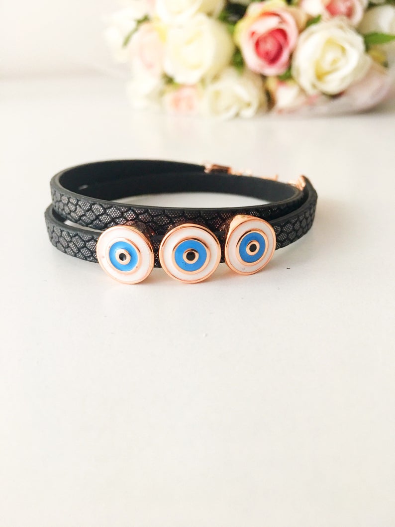 Handmade Evil Eye Bracelet featuring a blue charm on a leather strand, adjustable design, and tarnish-resistant stainless steel.