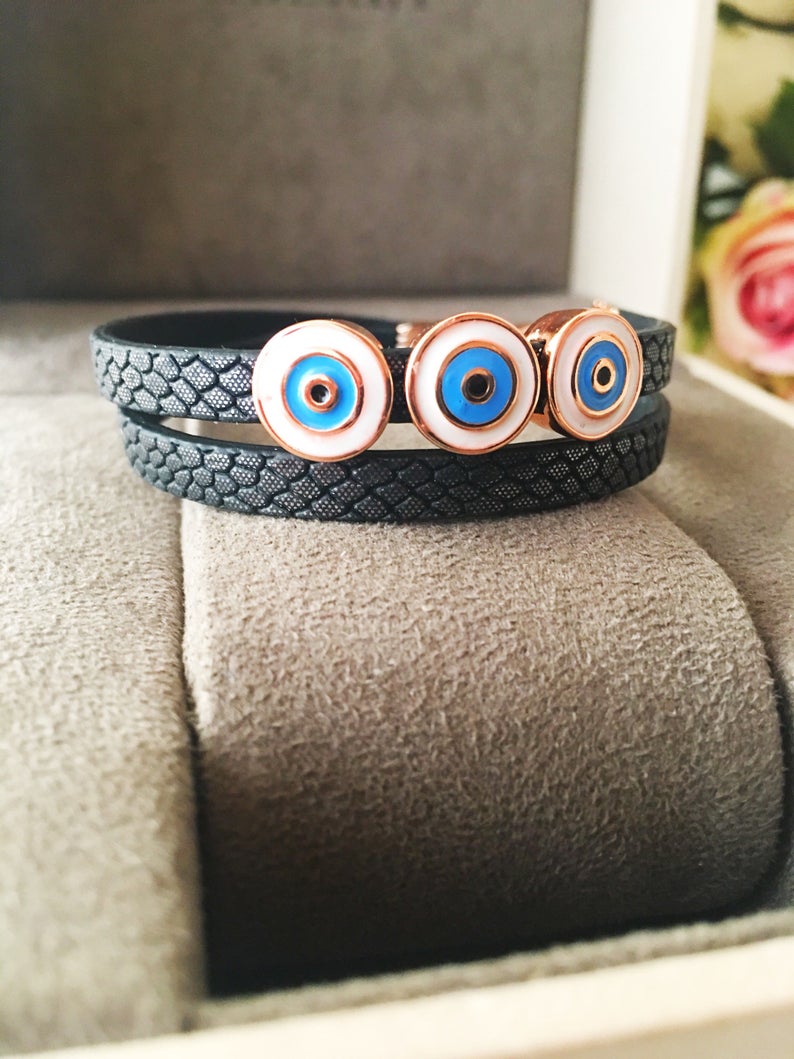 Handmade Evil Eye Bracelet featuring a blue charm on a leather strand, adjustable design, and tarnish-resistant stainless steel.