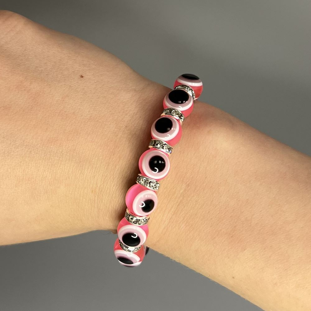 A beautifully crafted pink evil eye bracelet featuring a traditional charm, symbolizing protection and good luck, handmade with care.