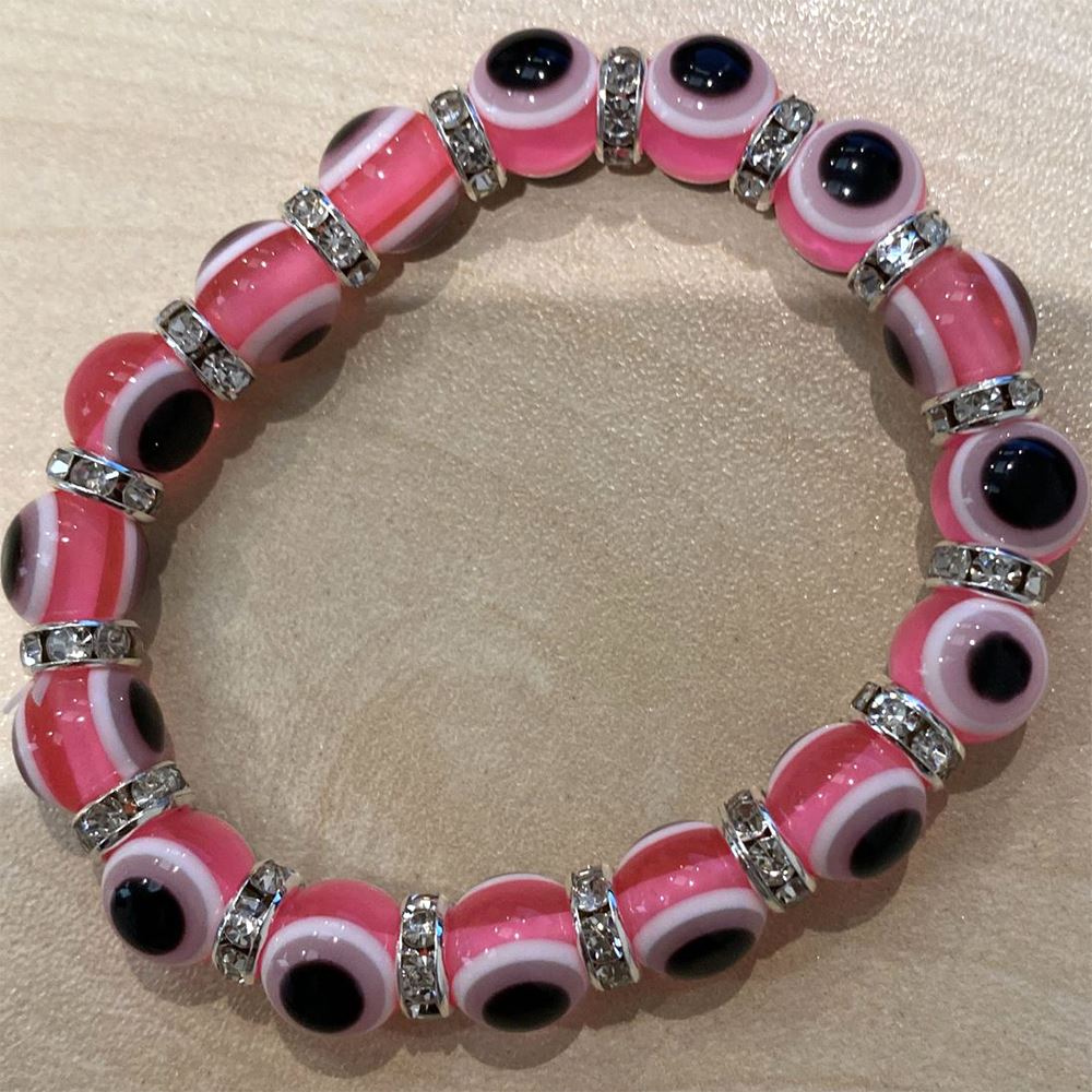 A beautifully crafted pink evil eye bracelet featuring a traditional charm, symbolizing protection and good luck, handmade with care.