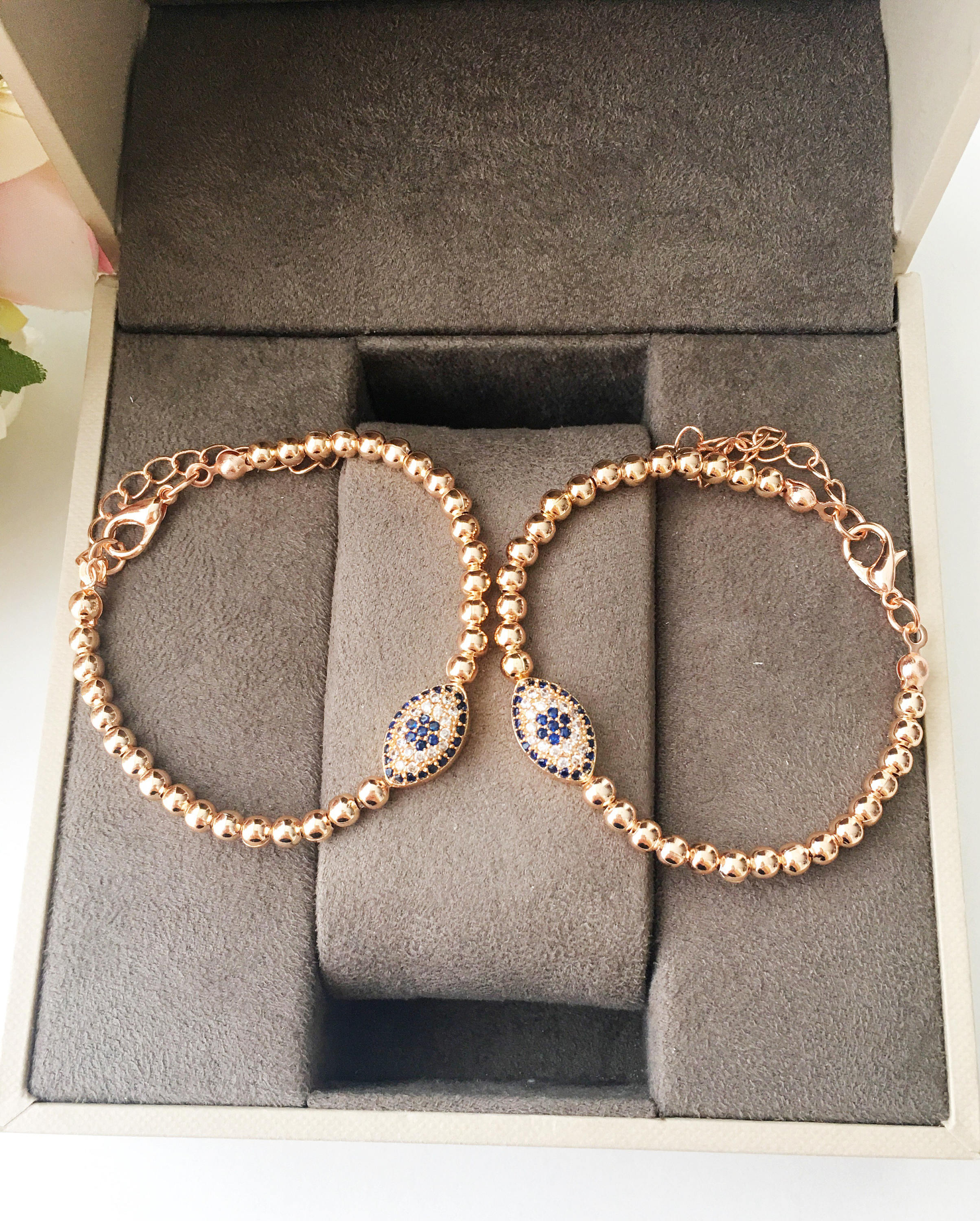 Elegant Evil Eye Bracelet featuring rose gold beads and adjustable design, made from tarnish-resistant 316L stainless steel.