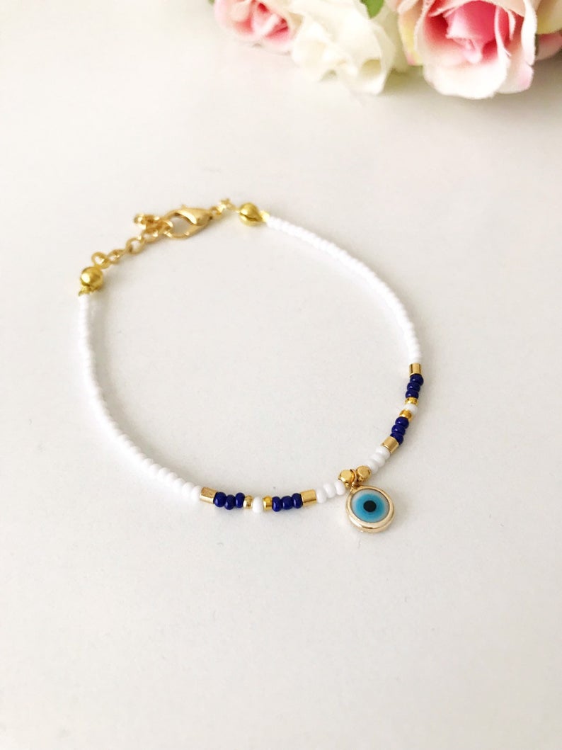 Handmade Evil Eye Bracelet featuring Miyuki seed beads in blue, turquoise, and white colors with an evil eye charm.