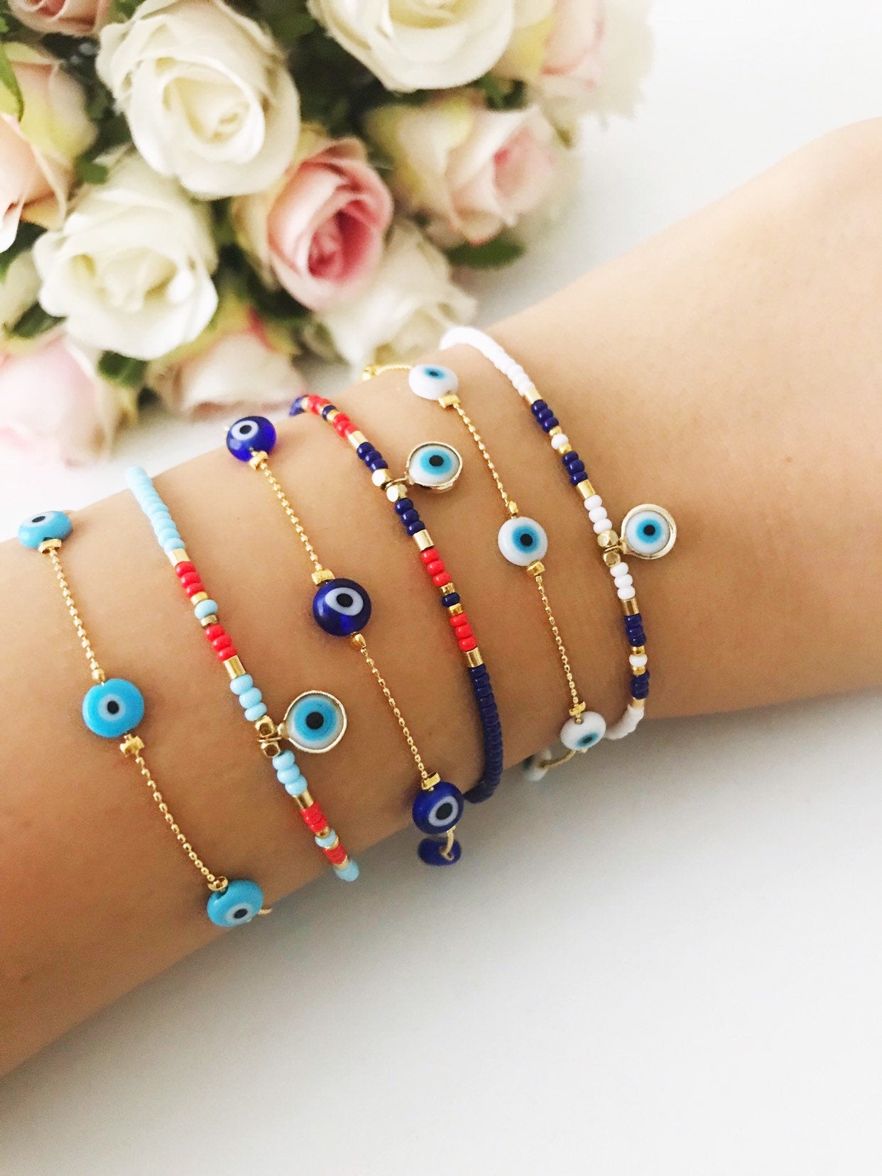 Handmade Evil Eye Bracelet featuring Miyuki seed beads in blue, turquoise, and white colors with an evil eye charm.