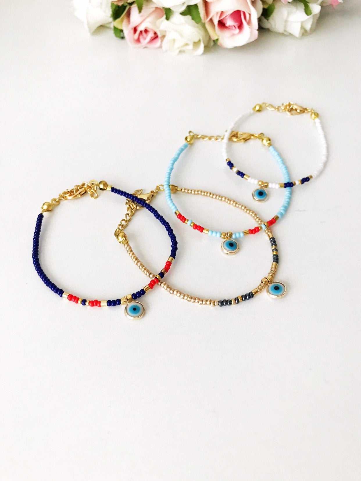 Handmade Evil Eye Bracelet featuring Miyuki seed beads in blue, turquoise, and white colors with an evil eye charm.